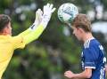 Bendigo City under-16 striker Kai Thomas tries to head the ball clear of Eltham's goalkeeper. Picture by Darren Howe