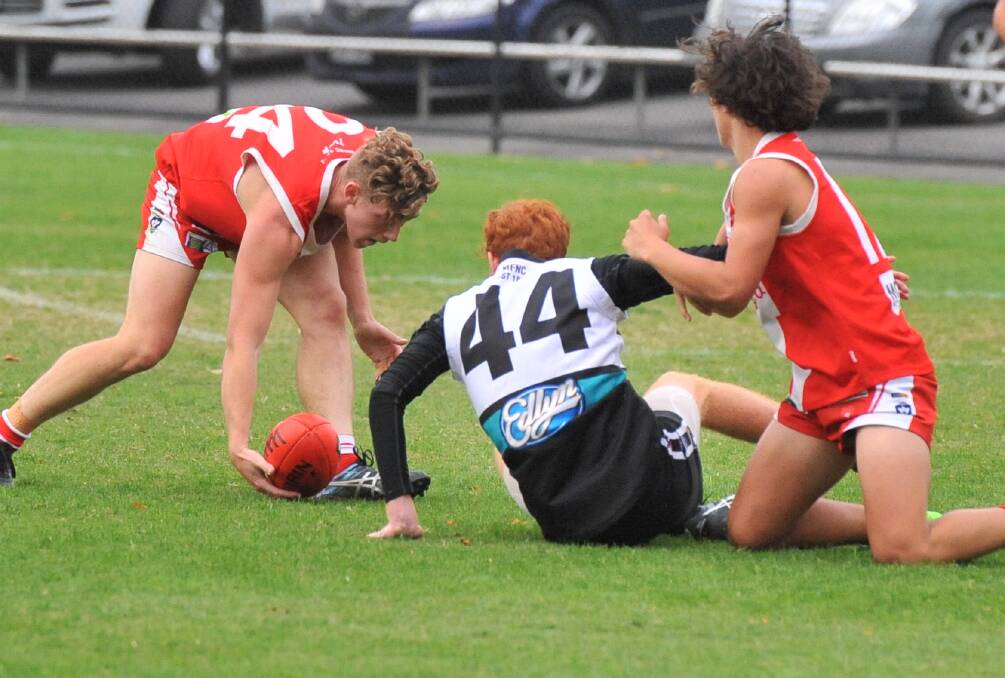 SWOOP: Kaiden Antonowicz picks up a loose ball against Maryborough at the Queen Elizabeth Oval. Picture: ADAM BOURKE
