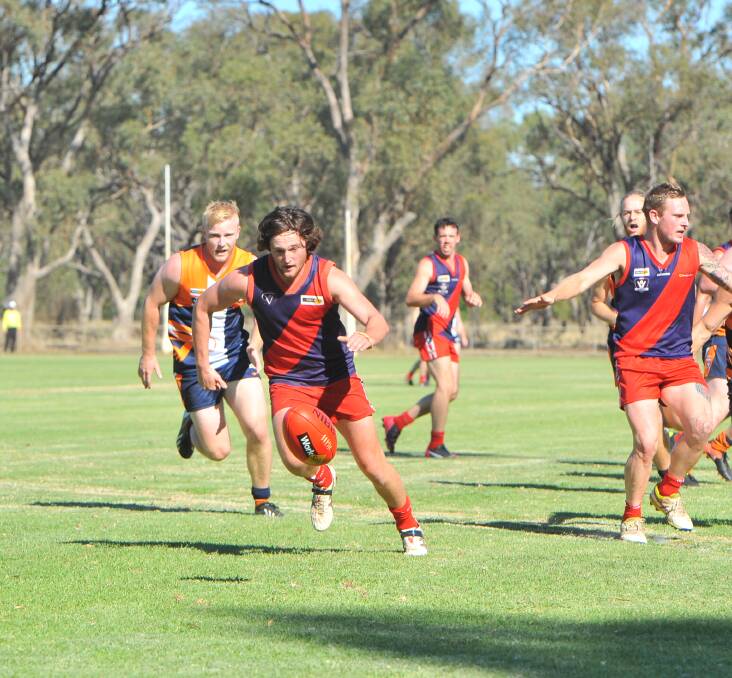 EYES ON THE BALL: Calivil United midfielder Sam Green leads the race for the ball in the first quarter of the Demons clash with Maiden Gully YCW Eagles.