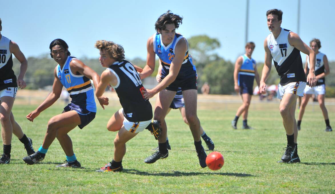Bendigo Pioneers big man Tom Campbell chases a hard ball get against the Rebels. Picture: ADAM BOURKE