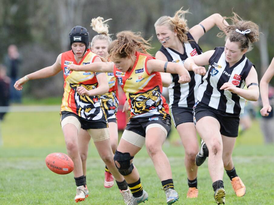 FIERCE BATTLE: Action from the youth girls game between Woorinen and Castlemaine.
