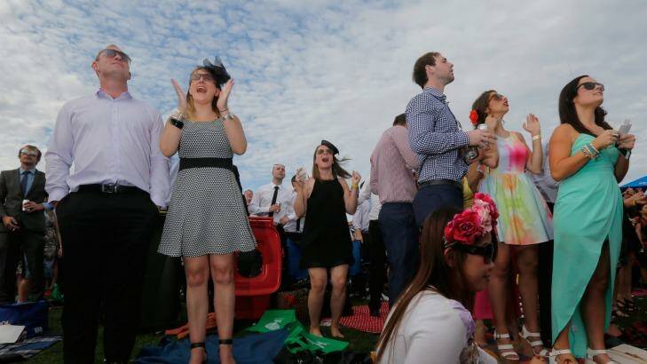 Racegoers enjoy the warm weather on Caulfield Cup Day, but the good run is about to end.  Photo: Luis Ascui