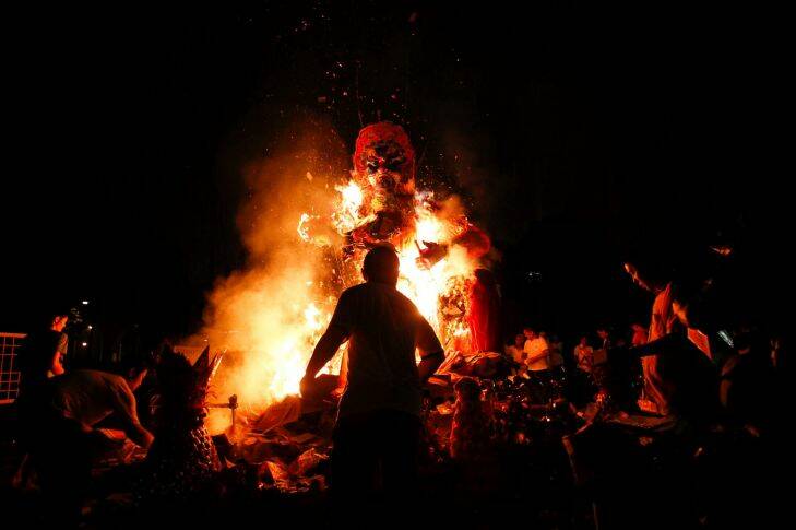 Malaysian Chinese people burn a giant paper statue of the Chinese deity "Da Shi Ye" or "Guardian God of Ghosts" during the Chinese Hungry Ghost Festival in Kuala lumpur, Malaysia, Thursday, Sept. 7, 2017. The Hungry Ghost Festival is celebrated during the seventh month of the Chinese lunar calendar, when prayers are offered to the dead and offerings of food and paper-made models of items such as televisions, refrigerators and sport cars are burnt to appease the wandering spirits. It is believed that the gates of hell are opened during the month and the dead ancestors return to visit their relatives. (AP Photo/Daniel Chan)