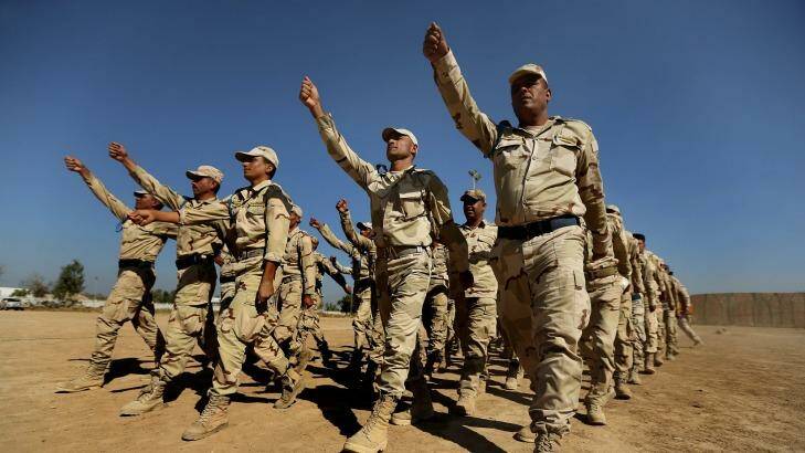Fighting force: Iraq army recruits march during their training at Baghdad Combat School. Photo: Kate Geraghty
