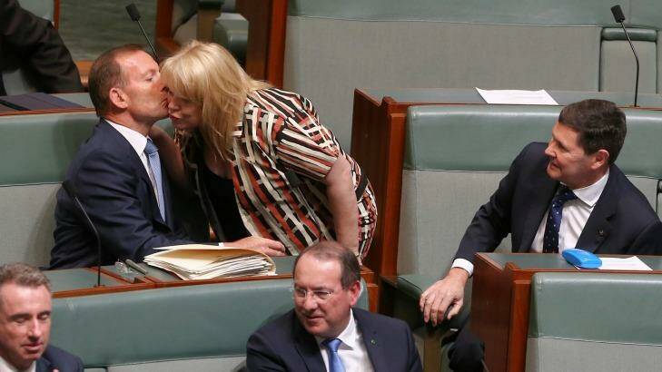 Former Prime Minister Tony Abbott and former Defence Minister Kevin Andrews are greeted by colleague Natasha Griggs as they take their seats on the backbench for question time. Photo: Alex Ellinghausen