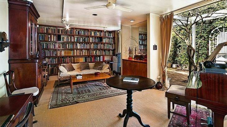Inside, the home has a generous living room complete with a baby grand piano. Photo: Supplied