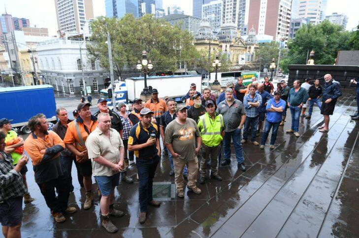 The Age, News, 21/03/2017 picture by Justin McManus. Log trucks parked around State Parliament to protest the closure of the Heyfield Timber Mill. Truckers on the steps of Parliament. Photo: Justin McManus