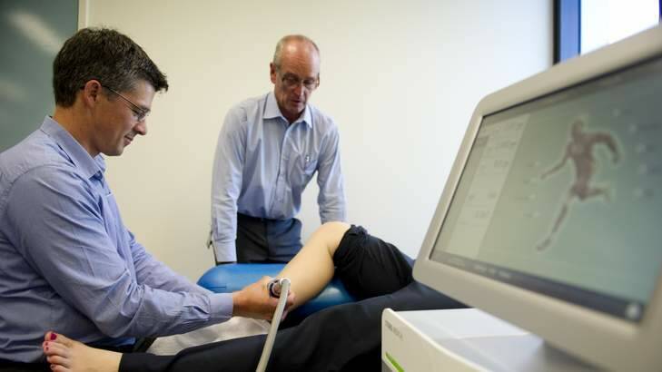 Assistant Professor Physiotherapy Phil Newman and Professor Physiotherapy Gordon Waddington with the Storz Medical Duolith SD1 machine being used to treat Shin Splints. Photo: Jay Cronan
