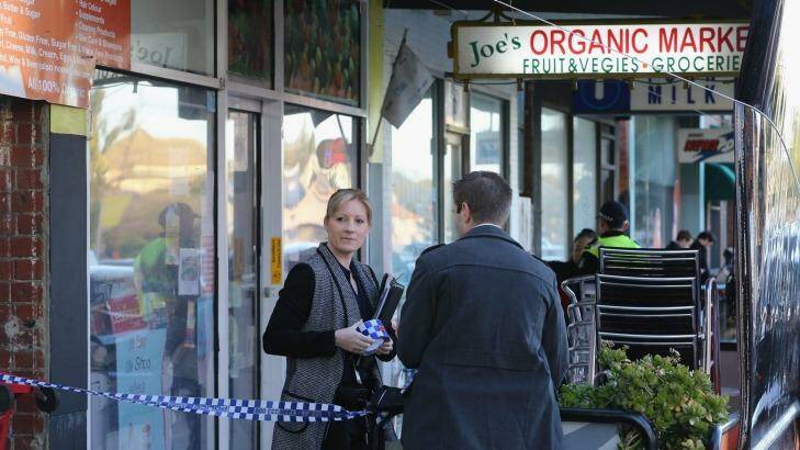 Police outside Joe's Organic Market on Victoria Road. Photo: Wayne Taylor