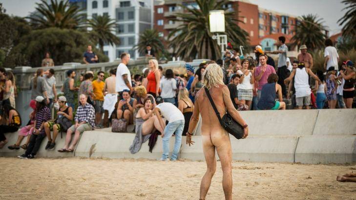 A weary partier awakes to find himself nude and highly visible at St Kilda Beach on New Year's Day. Photo: Chris Hopkins