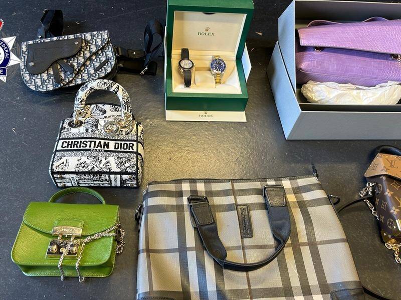 Designer watches and goods were seized during a raid on a property linked to a Chinese crime gang. (HANDOUT/AUSTRALIAN FEDERAL POLICE)