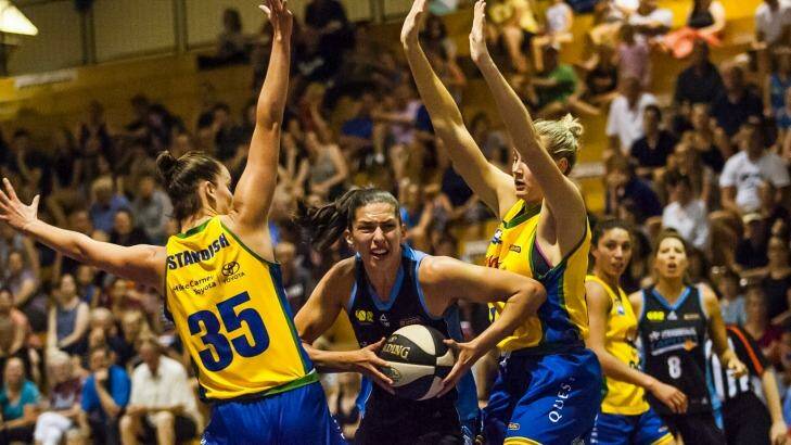 Capitals captain Marianna Tolo fights her way through the Townsville defence on Saturday.  Photo: Elesa Kurtz