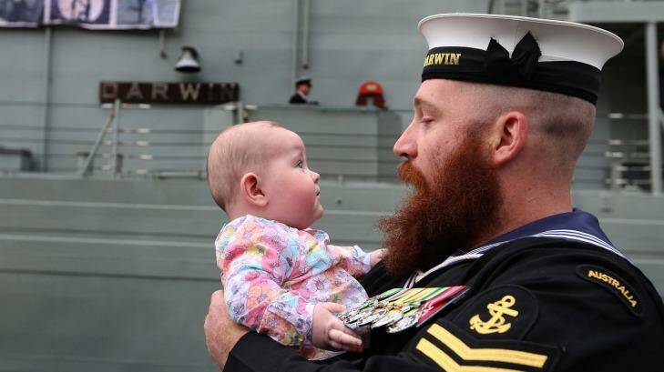 Family support: Leading Seaman Brent Anschaw meets his new daughter, Olivia, for the first time after returning from the Gulf. Photo: James Alcock