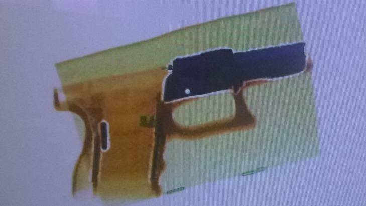 AN X-ray image of a gun part.