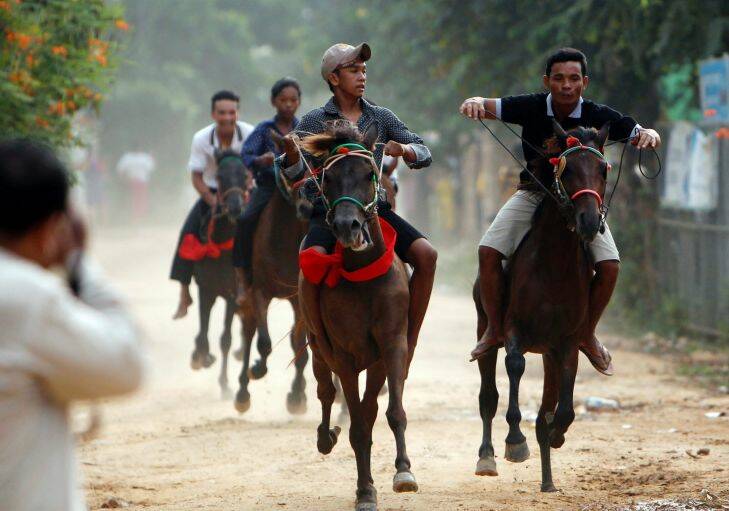 Locals ride on their horses for racing as part of the festival of Pchum Ben, or Ancestors' Day at Vihear Sour pagoda in Kandal province, northeast of Phnom Penh, Cambodia, Wednesday, Sept. 20, 2017. Residents of the village on Wednesday held the annual water buffalo race to mark the end of the traditional 15-day religious festival, which commemorates the spirits of the dead, widely known in the country as Festival for the Dead. (AP Photo/Heng Sinith)