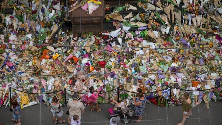 Crowds still gather at the floral tribute memorial commemorating the lives of the five people killed during the Bourke Street tragedy . scores of people were mowed down by a car allegedly driven by accused killer Dimitrious Gargasoulas. 30th January 2017. Photo by Jason South