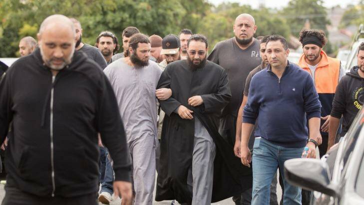 Sheikh Mohamad Abou Eid wears dark glasses as he walks to Preston Mosque before Friday prayers. Photo: Jason South