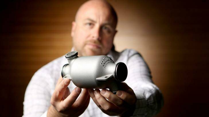 Engineer Michael Fuller shows off the 3D printed heat exchanger he has developed for Formula One teams. Photo: Wayne Taylor