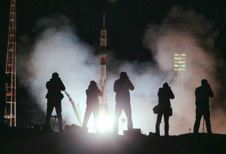 Journalist takes photos of the Soyuz-FG rocket booster with Soyuz MS-06 space ship carrying a new crew to the International Space Station, ISS, blasting off at the Russian leased Baikonur cosmodrome, Kazakhstan, Wednesday, Sept. 13, 2017. A Soyuz space capsule with two Americans and a Russian aboard has blasted off for the International Space Station from Russia's manned launch facility in Kazakhstan. (AP Photo/Dmitri Lovetsky)