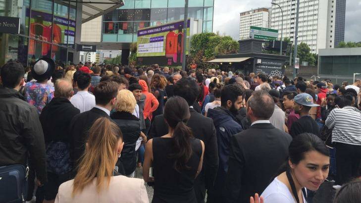 Shoppers wait outside Westfield after being evacuated. Photo: Michael Chammas