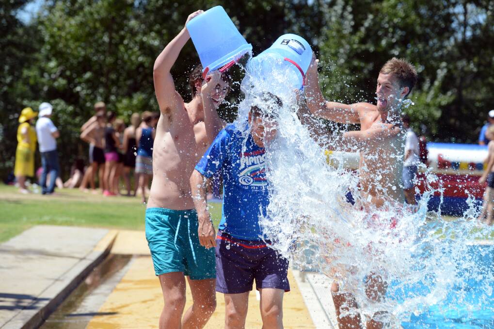Bendigo Senior Secondary College principal Dale Pearce is cooled down by two students at the school swimming sports day.

Picture: Jim Aldersey
050213