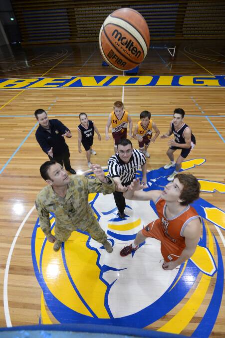 Sergeant Shane Ellison from the Defence Force Recruits lines up against Josh Garlepp with Josh Pell, Jess Abe, Liam Radford, Referee Marcus Nancarrow, Kayle Thompson and Tanner Rayner ready for the tap out at the Bendigo Stadium. Defence Force Recruits have signed on as the Major Partner of the Bendigo Basketball Competition.


Picture: Jim Aldersey
300513