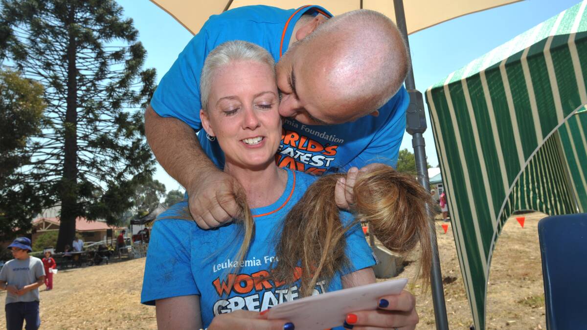 Harcourt couple Michelle and Garry Holmes participated in the worlds greatest shave at the Harcourt Community Market. Michelle glances in the mirror for the first time following her hair shave
pic Julie Hough 20.01.13