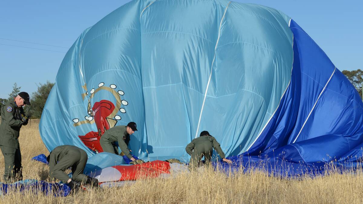 The crew deflate the balloon. 

Picture: JODIE DONNELLAN 