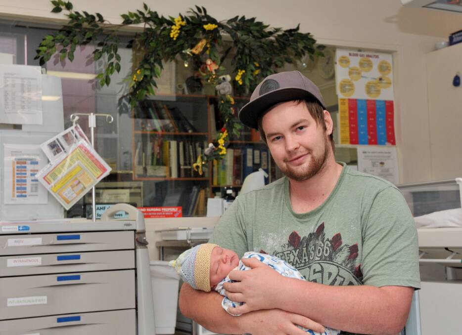 Special: Jackson Hayes holds Chayse for the first time. Picture JODIE DONNELLAN