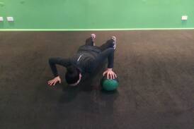 Amy demonstrates a medicine ball push-up.