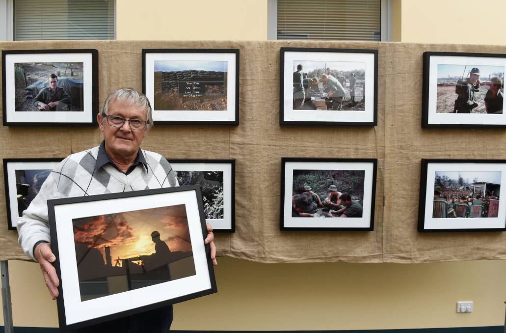 War: Paul Haw with some of the photos on display at St John of God. Picture: JODIE WIEGARD