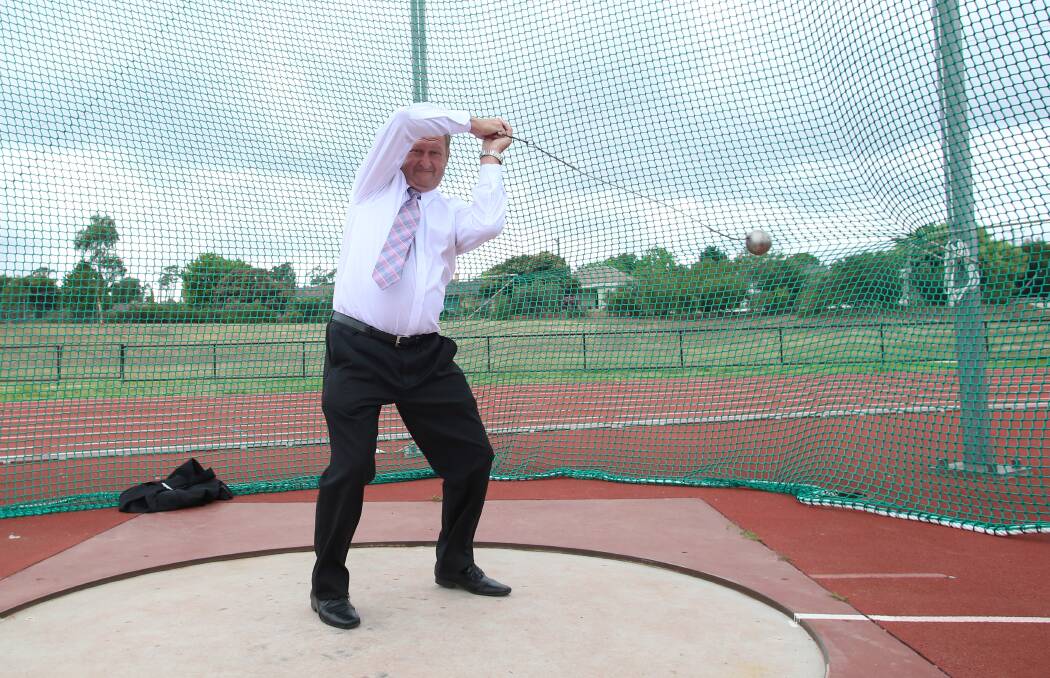 TROOPER: Mayor Barry Lyons attempts a hammer throw. Picture: PETER WEAVING