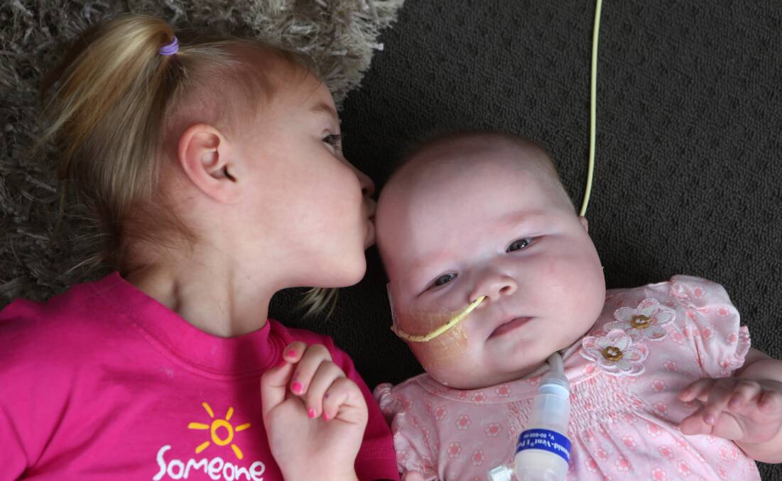 LOVE: Isabella Stove, 3, with her sister baby Evie. Picture: PETER WEAVING