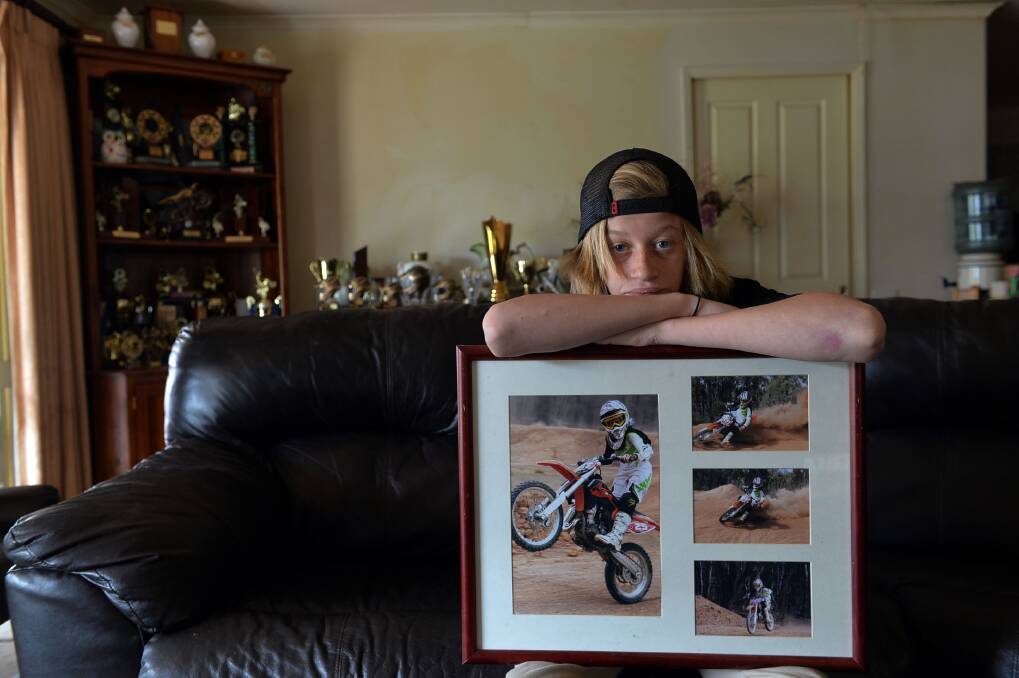 SAD: Harry Smith with a photo of his beloved bikes. Picture: BRENDAN McCARTHY