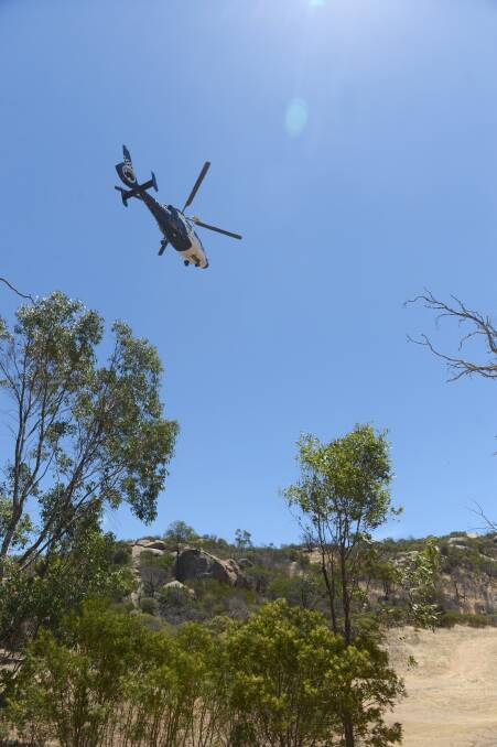 FLYING HIGH: The police airwing help with the search for Wayne Amey's body. 