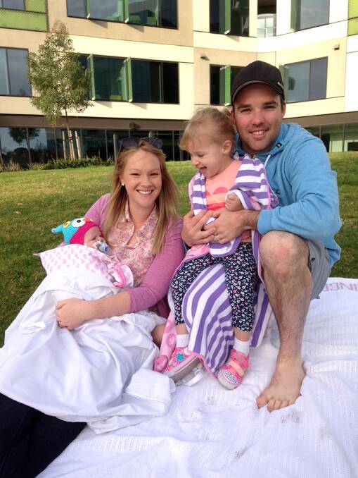 BRAVE: Baby Evie stove with mum Emily, sister Bella and dad Andrew. Picture: SUPPLIED