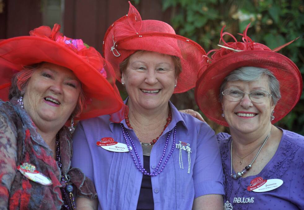 COLOURFUL: Helena Muster, Gwenda Baker and Jeanette Scott from the Red Hat Society's Bendigo Golden Gadabouts. Picture: BRENDAN McCARTHY
