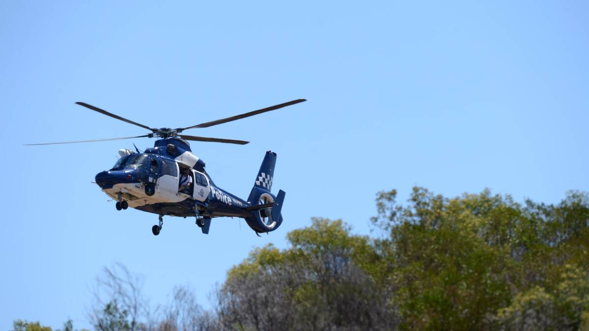 FLYING HIGH: The Police airwing scans the area looking for the body of Wayne Amey. Picture: JIM ALDERSEY
171213