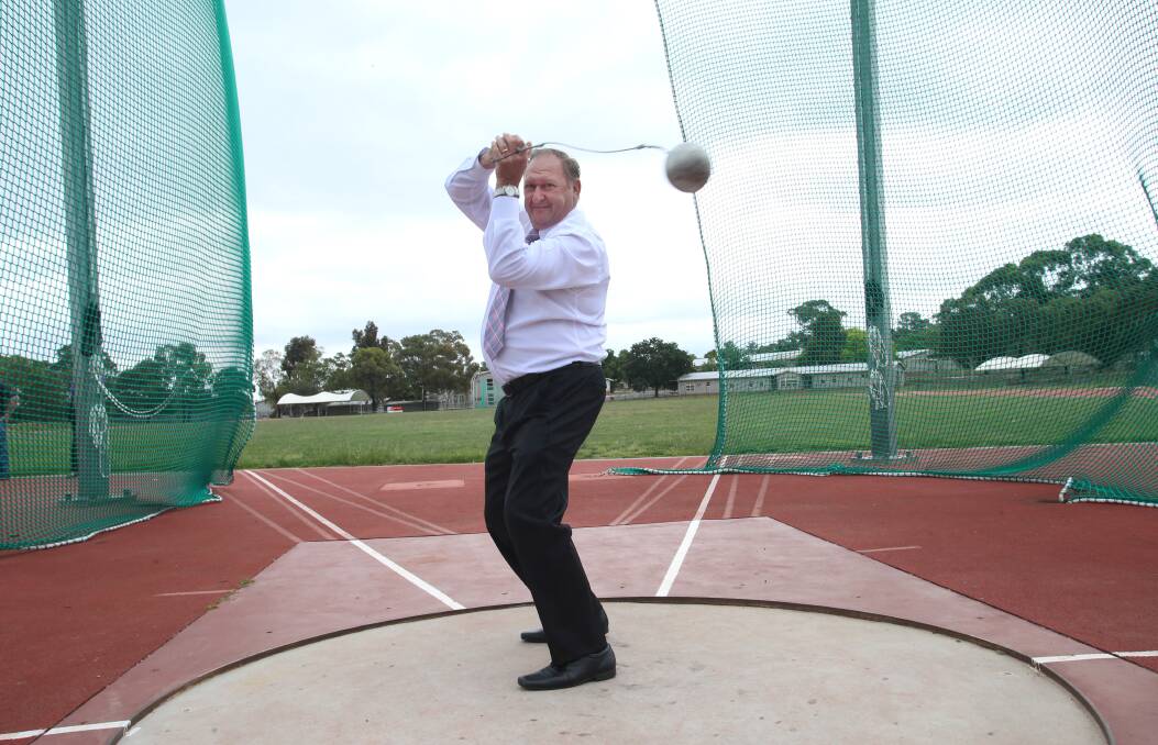 TROOPER: Mayor Barry Lyons attempts a hammer throw. Picture: PETER WEAVING