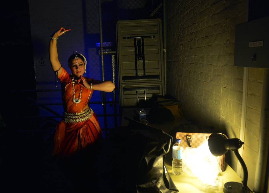 Monica Singh practises in the wings before going on stage to perform traditional Indian Odissi dancing at the Festival of Cultures closing concert. Picture: BRENDAN MCCARTHY