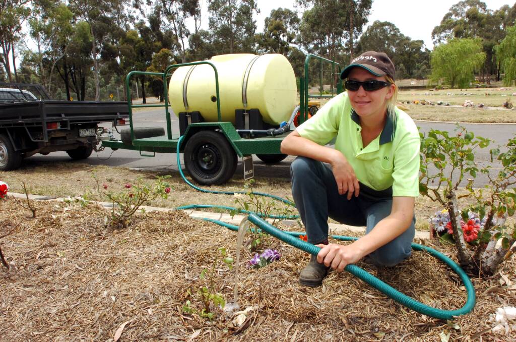 Jess Chambers an Apprentice in Horticulture with the cemeteries trust uses dam water to keep rose gardens alive at the Eaglehawk Cemetery. Picture ; PETER HYETT.