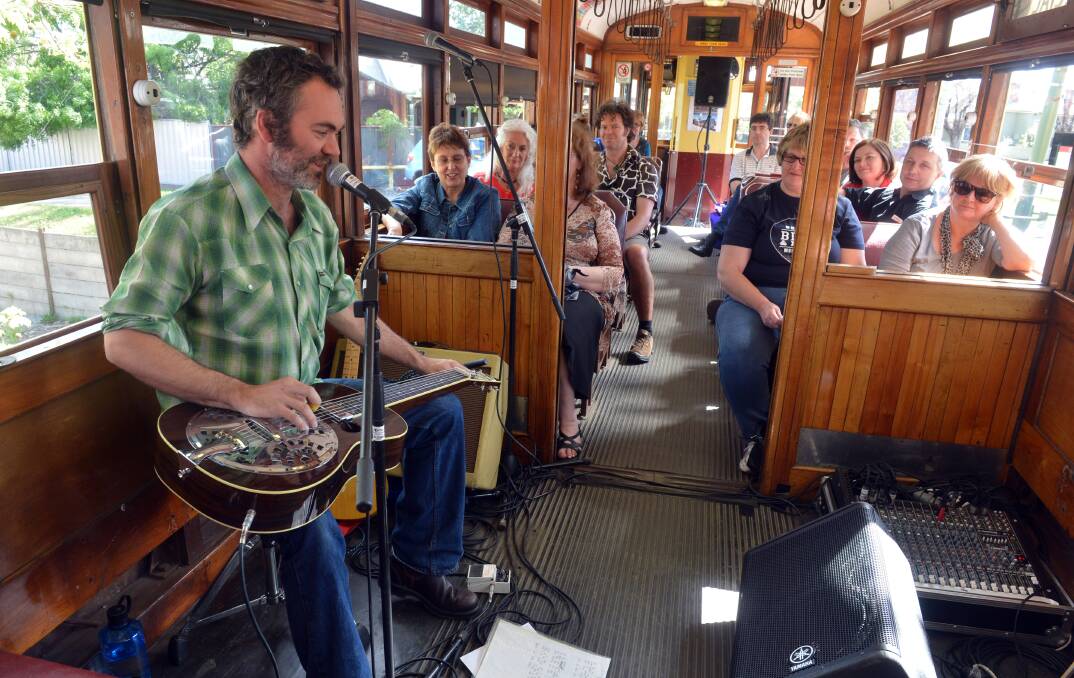 Tully Sumner playing on the Blues Tram. Picture: BRENDAN MCCARTHY