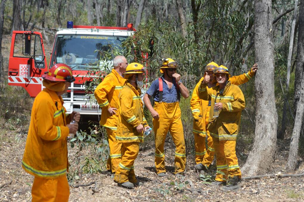 The CFA and DEPI mop up a blaze believed to be started by Lightning near Axe Creek. Picture: JIM ALDERSEY