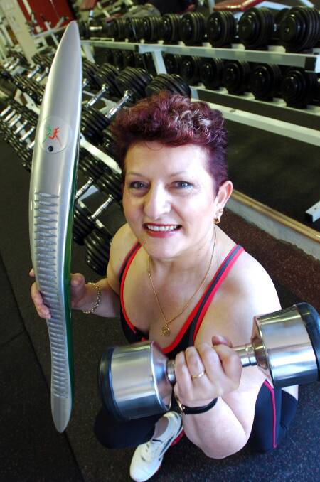 Power Lifter Helen Kostadinos at training and with the Commonwealth Games baton. Picture ; PETER HYETT.