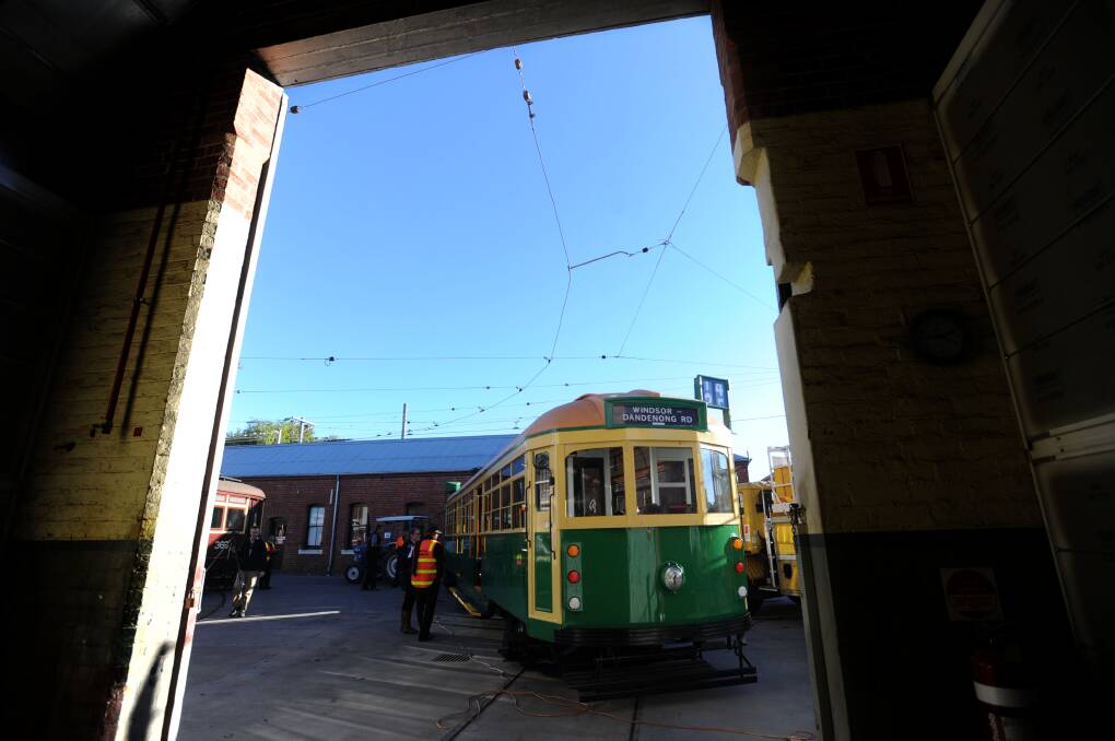 A shiny new looking W-class Melbourne tram will is towed out of the Bendigo depot and put on a truck to Melbourne. Bendigo Tramways staff put some finishing touches on the tram. Picture: JODIE DONNELLAN