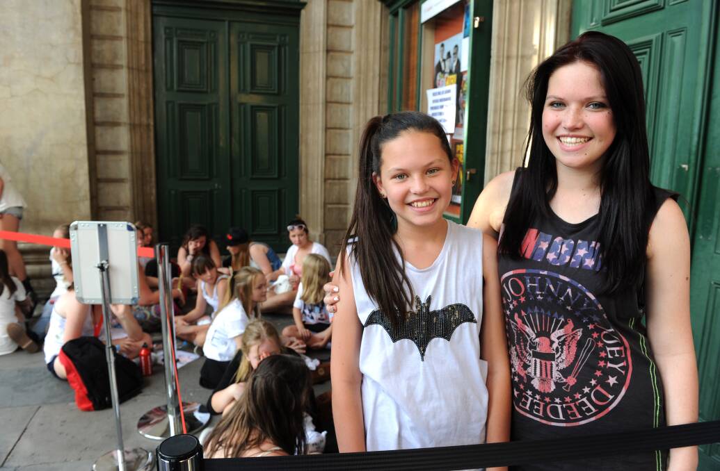 Rachel, 13 and Becca Smith, 15 were at the front of the line.  Picture: JODIE DONNELLAN 