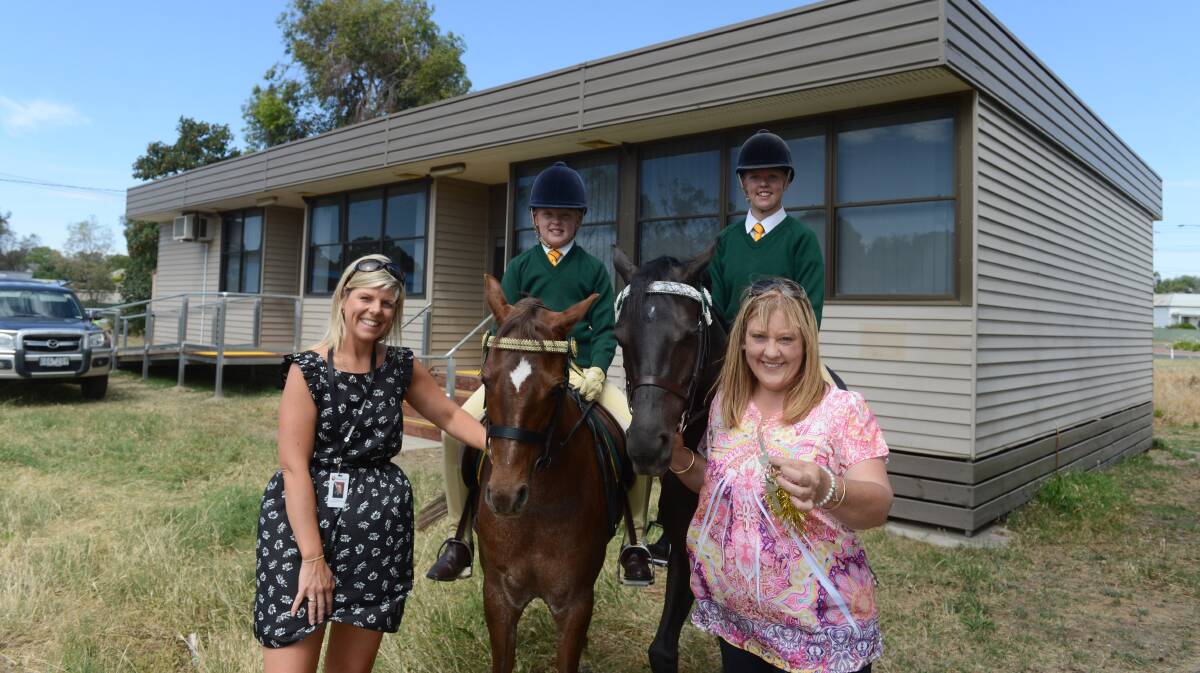THRILLED: CoGB project manager Kendyl Hopley, Montanna Maud with her pony Ascot Samsara, Morgan Maud with her pony Aspen Way Gala Rose and Lisa Maud with the keys to the Bendigo Pony Club's new Clubhouse. Picture: JIM ALDERSEY
