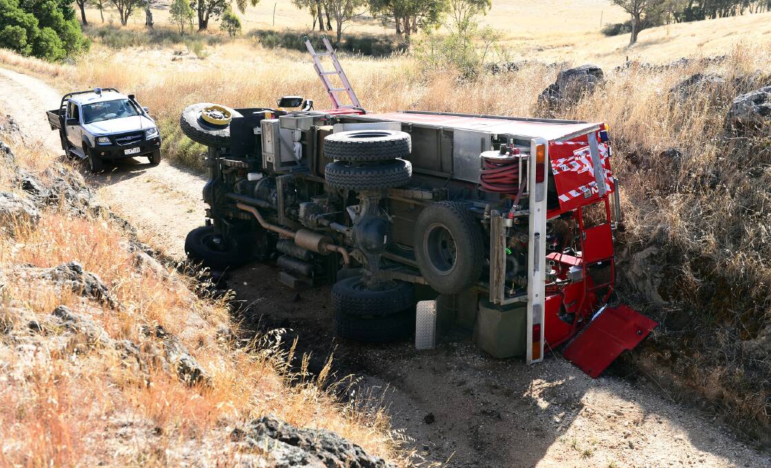 ROLL-OVER: A CFA fire truck clipped a rock and tipped while on the way to fire. Picture: JULIE HOUGH 