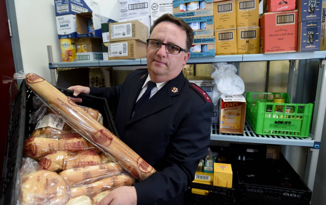 Captain Craig Wood with some of the food at the Salvation Army's Community Support Office in Bendigo. Picture: JODIE WIEGARD