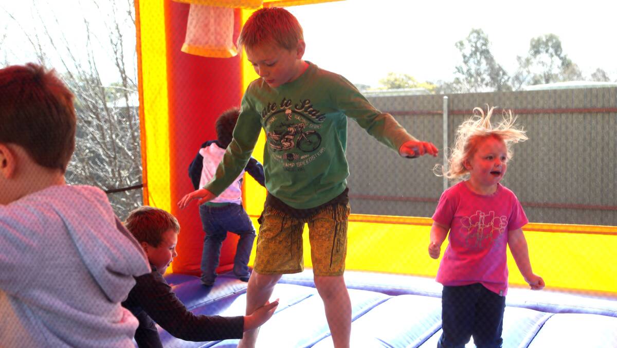 Children enjoy the bouncing castle during the fundraiser for a playground in honour of Zayden Veal-Whitting. Picture: PETER WEAVING